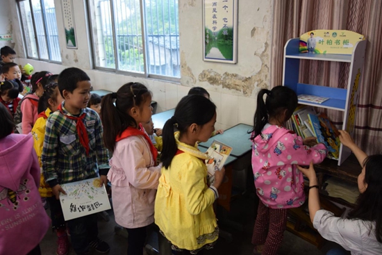 (重慶萬(wàn)州河口完全小學(xué)的孩子們排隊(duì)歸還葉柏公益捐贈(zèng)的繪本).jpg