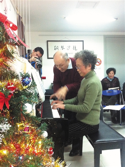 小區(qū)志愿者、鋼琴班方百里老師認真指導學員彈琴.jpg